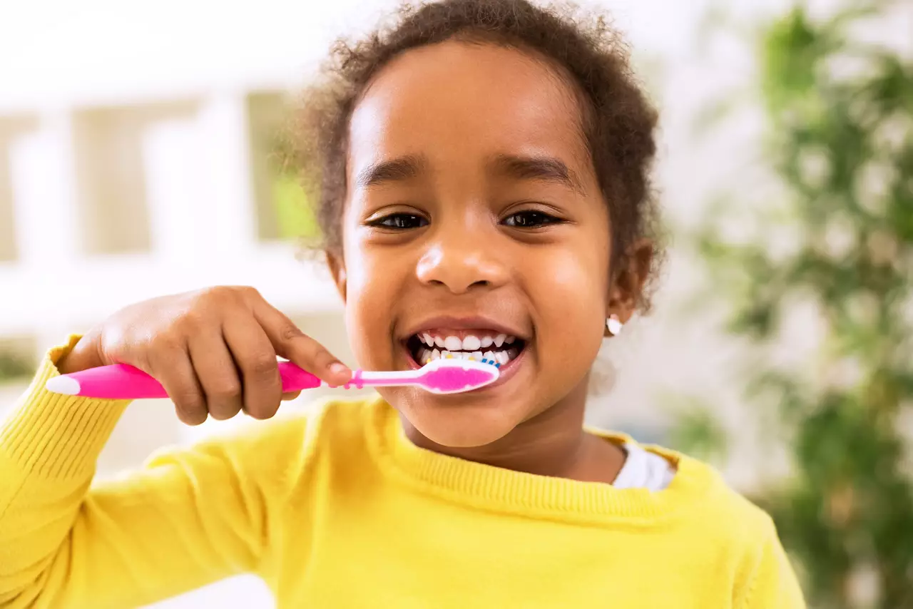 Little beautiful African girl brushing teeth, healthy concept