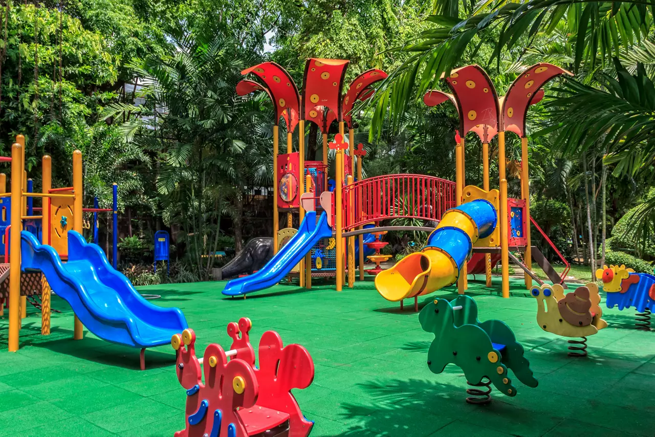 Colorful Playground with Green Elastic Rubber Floor for Children in the Park