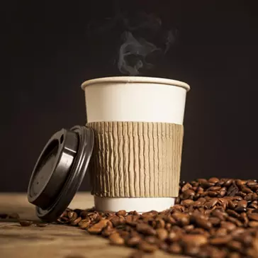 Coffee Cup with heat protection and lid and beans either side 