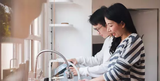 Couple washing dishes