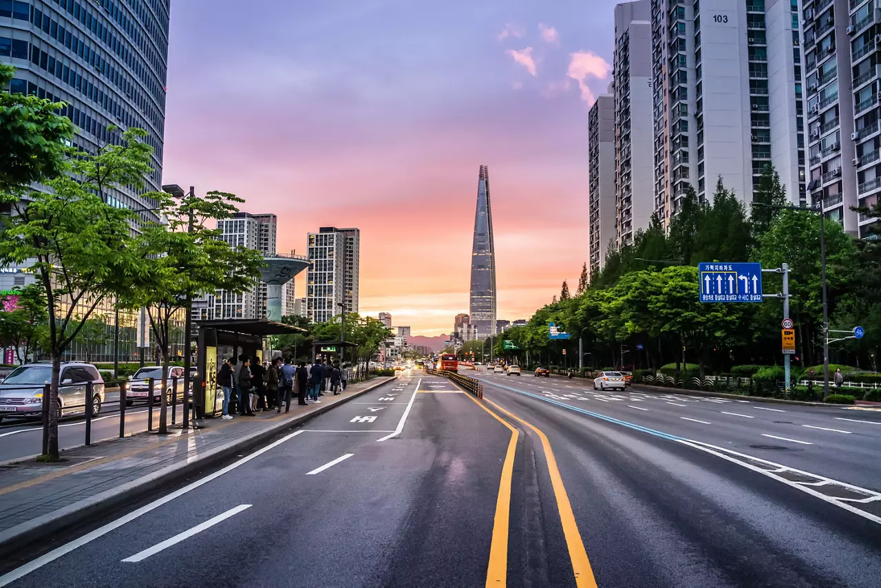 Road Amidst Buildings During Sunset In City