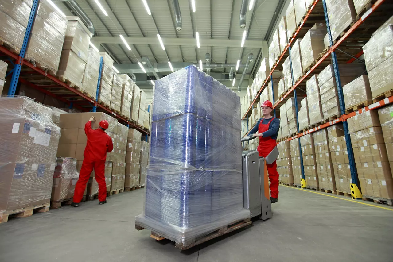 Warehouse worker moving a pallet of goods