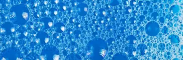 Clear foam bubbles in blue liquid