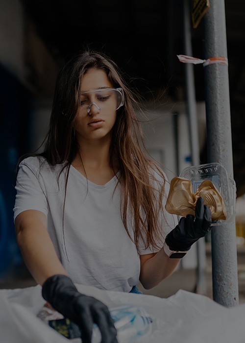 woman in white shirt sorting recyclable material