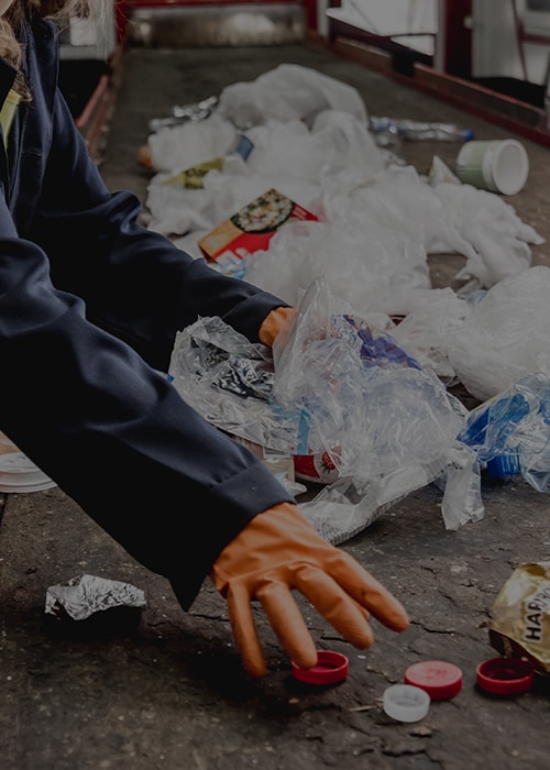 At modern recycling plant. Separate garbage collection. WorkersAt modern recycling plant. Separate garbage collection. Workers sorting trash to be processed. Trash sorting.