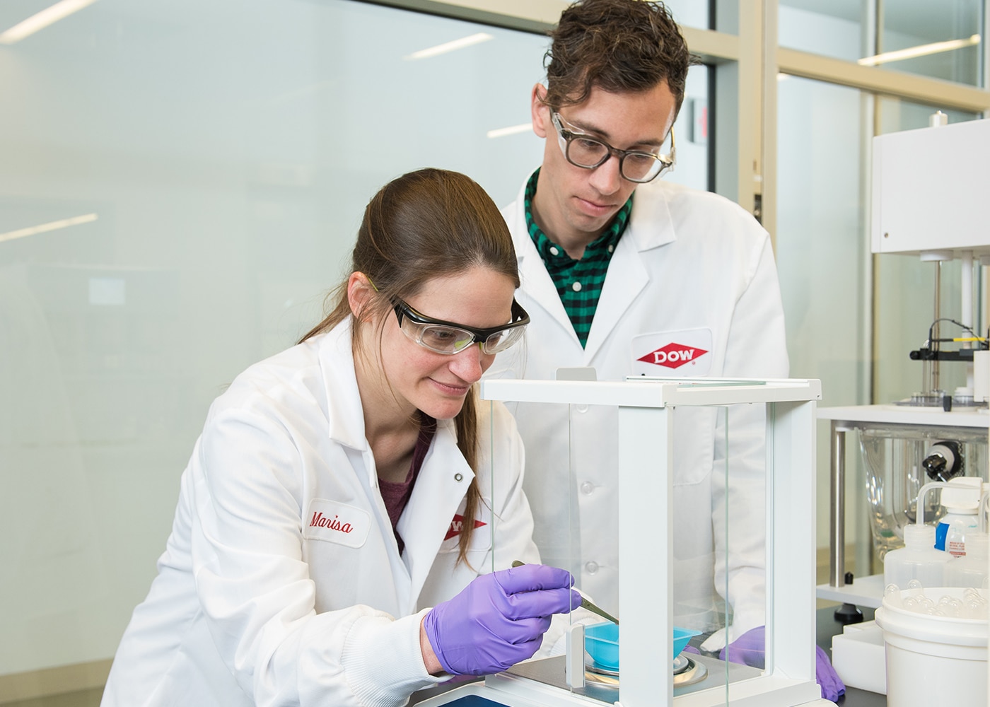 Two scientists work with equipment in the lab
