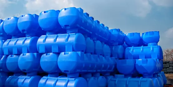 Blue storage containers for liquids stacked up.
