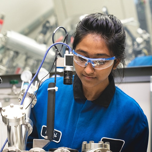 female Dow scientist works with lab equipment