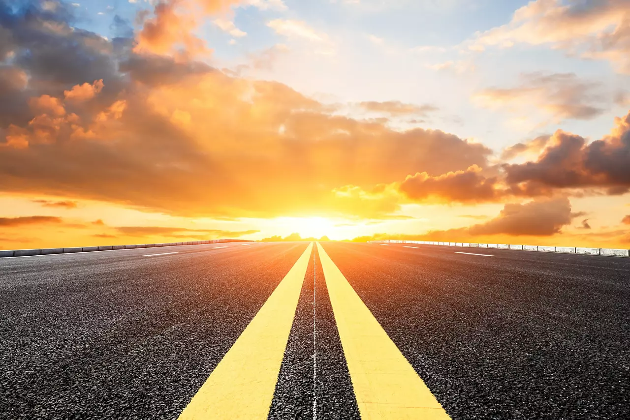 Asphalt road with highway lines and sky cloud landscape at sunset